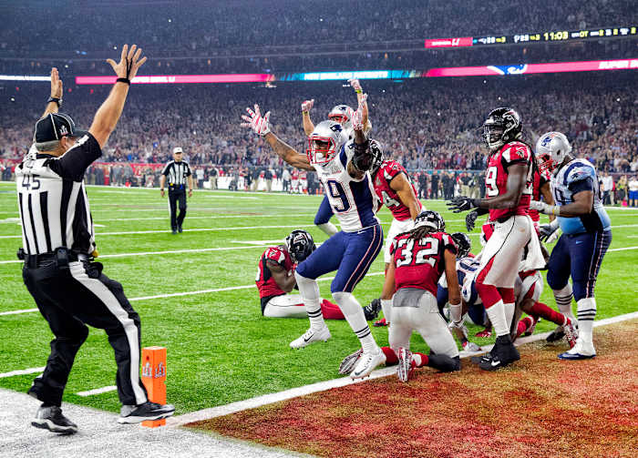 Malcolm Mitchell throws his hands up in celebration, mimicking line ref Jeff Seeman signaling the touchdown